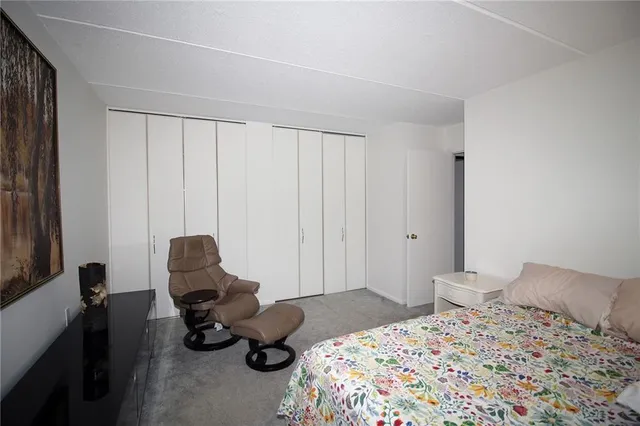 a bedroom with a bed chair and couch