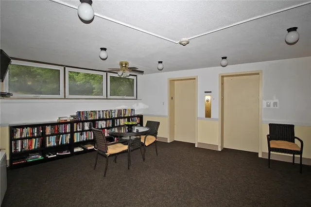 a dining room with furniture and a large window