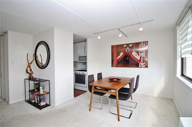 a work room with furniture and a fan
