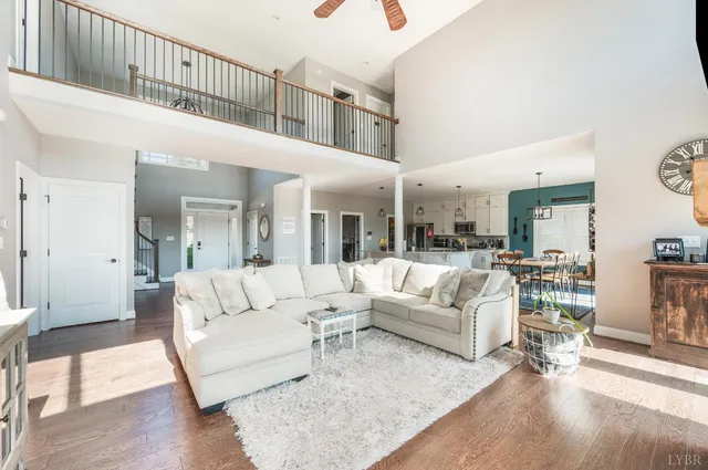 a living room with furniture a fireplace and wooden floor