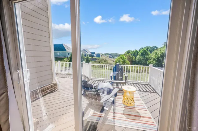 a view of a balcony with dining table and chairs
