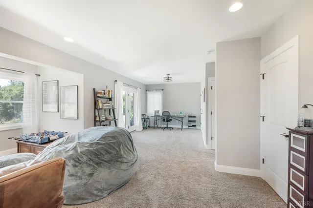 a large room with a refrigerator and a chandelier