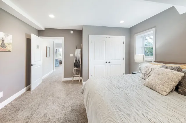 a living room with furniture and a dining table with kitchen view