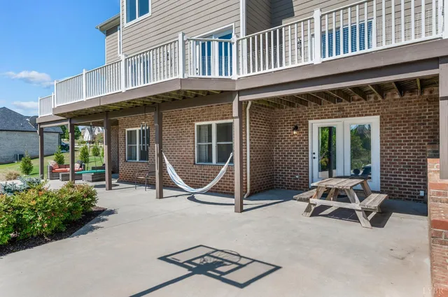 a view of a balcony with wooden floor and fence