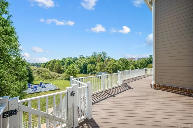 a view of a backyard with wooden fence
