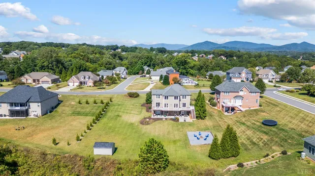 a view of house with yard in front of it