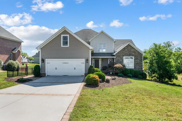a front view of house with yard and green space