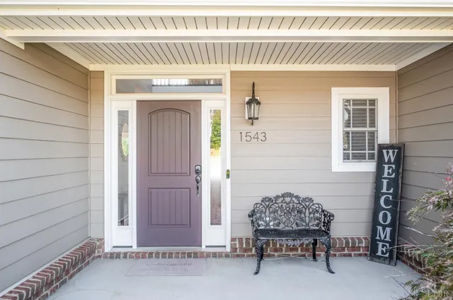 a couple of chairs in front of a house