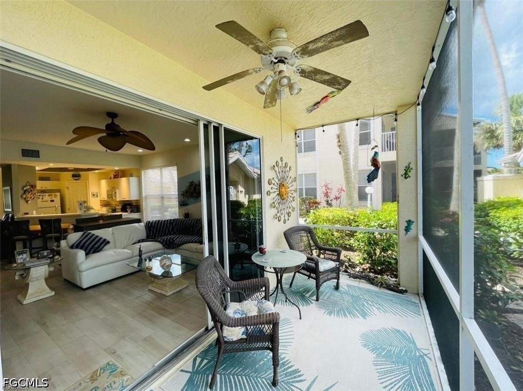 14971 Rivers Edge Court, Unit 101 Fort Myers, FL 33908 - Photo 4 of 9 a living room with furniture and a large window