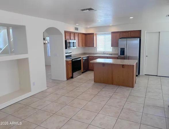 a kitchen with stainless steel appliances granite countertop a refrigerator and a sink