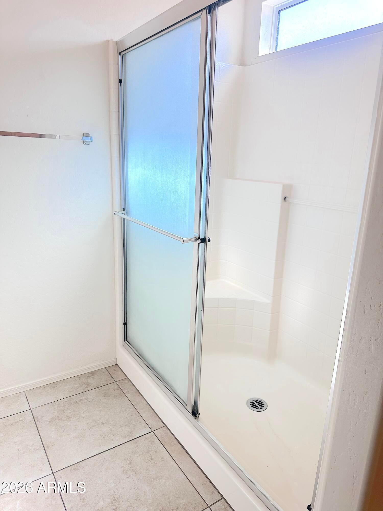 4106 East Chambers Street Phoenix, AZ 85040 - Photo 18 of 33 a bathroom with a glass shower door