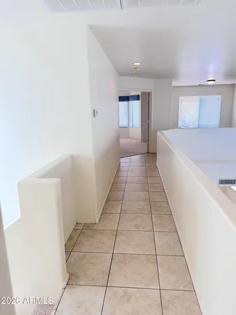 a hallway with a window and a couch