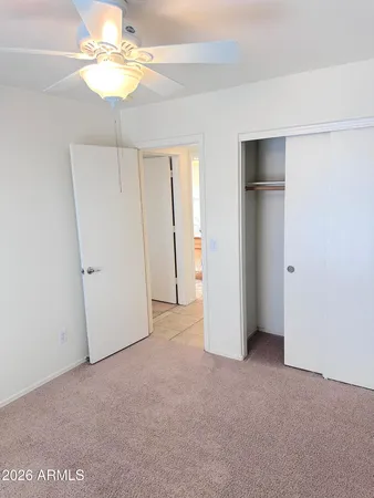 an empty room with a empty space and a ceiling fan