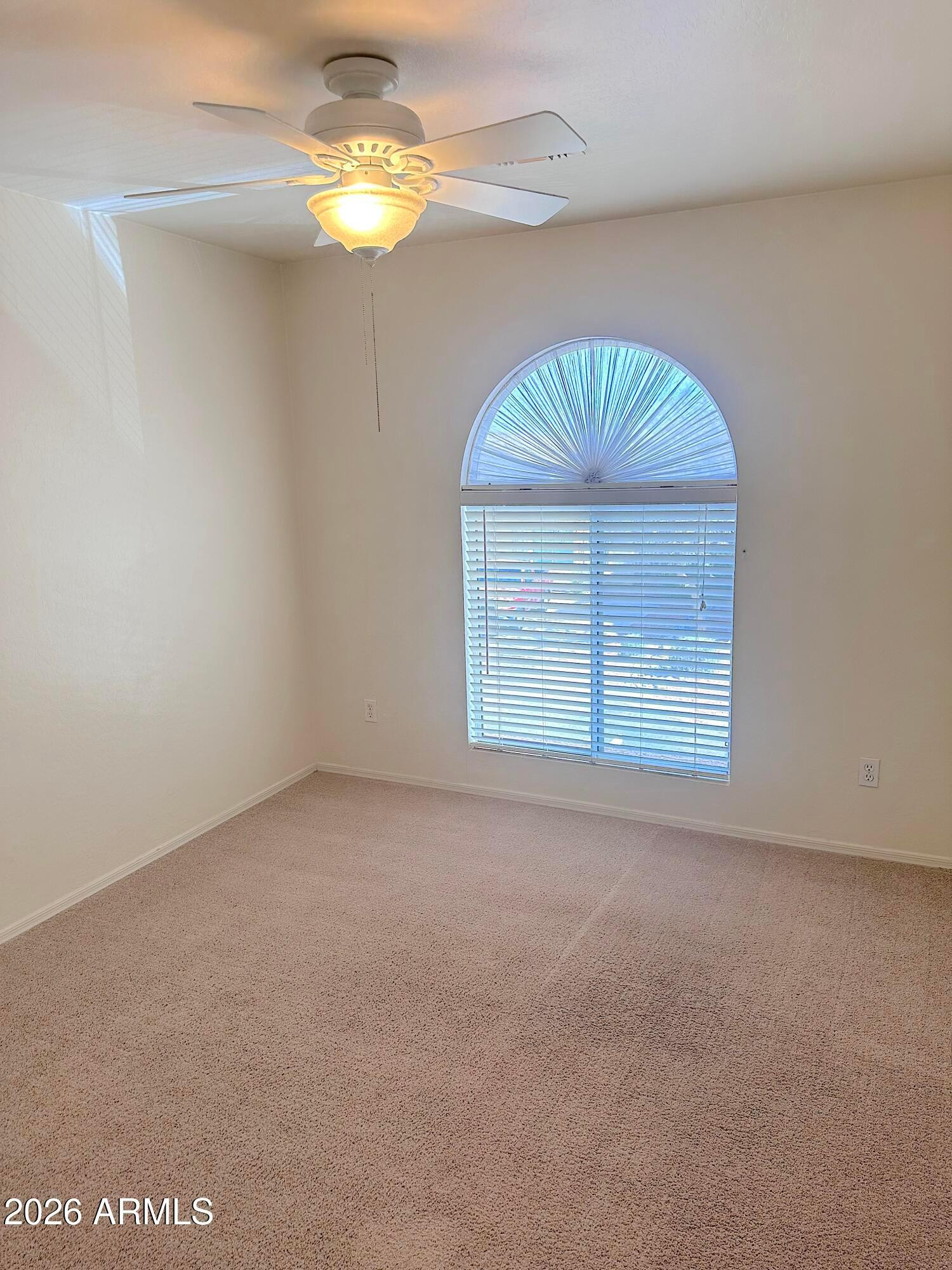 4106 East Chambers Street Phoenix, AZ 85040 - Photo 23 of 33 en empty room with windows and chandelier fan
