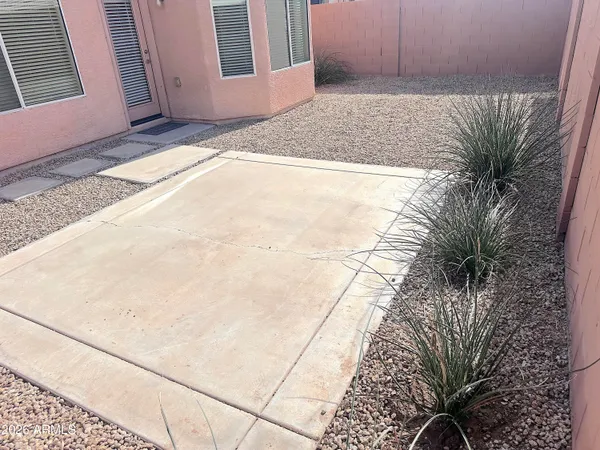 a backyard of a house with potted plants