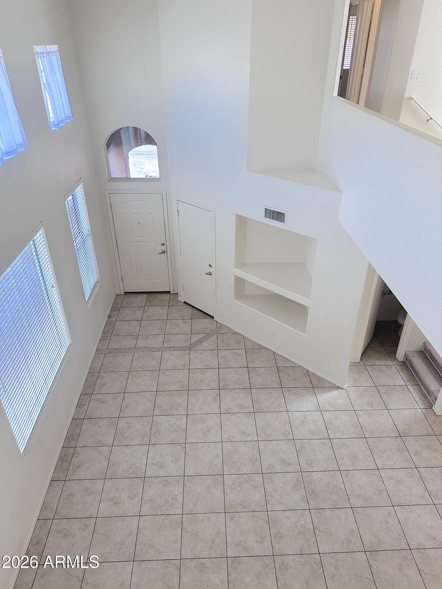 4106 East Chambers Street Phoenix, AZ 85040 - Photo 4 of 33 a view of a livingroom with an empty space and a window