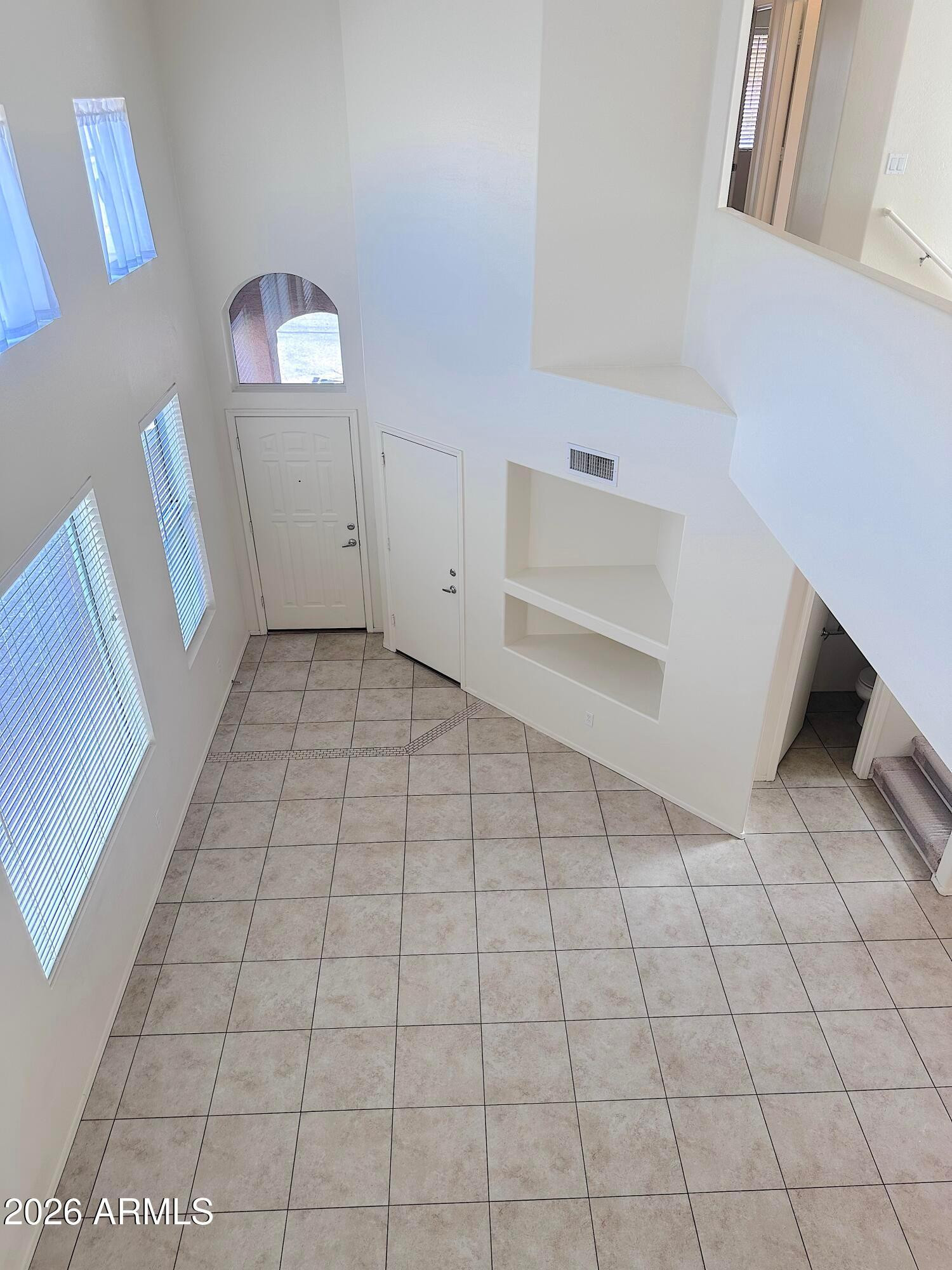 4106 East Chambers Street Phoenix, AZ 85040 - Photo 4 of 33 a view of a livingroom with an empty space and a window