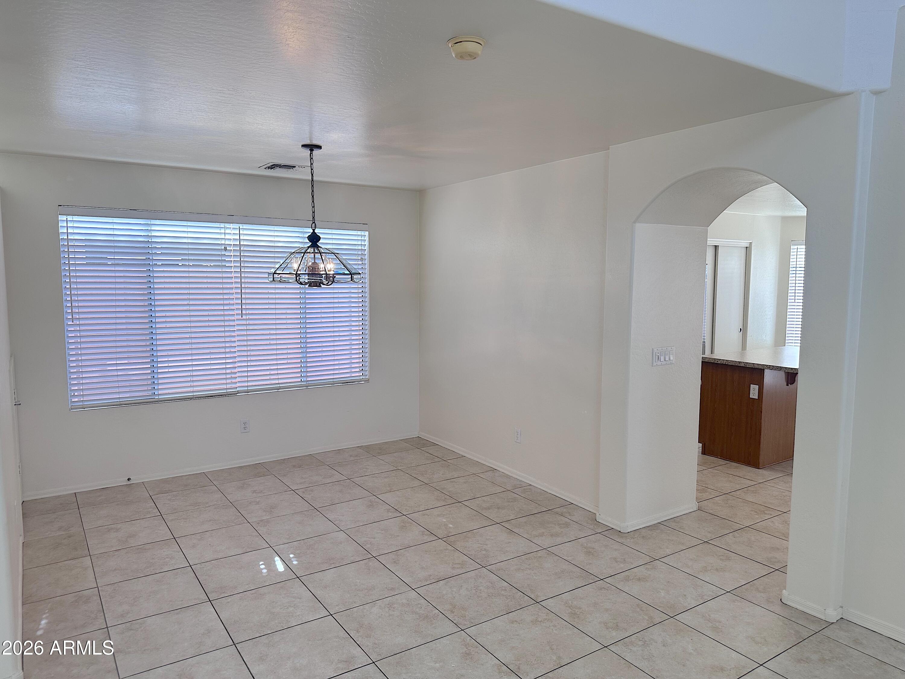 4106 East Chambers Street Phoenix, AZ 85040 - Photo 6 of 33 wooden floor in an empty room with a window
