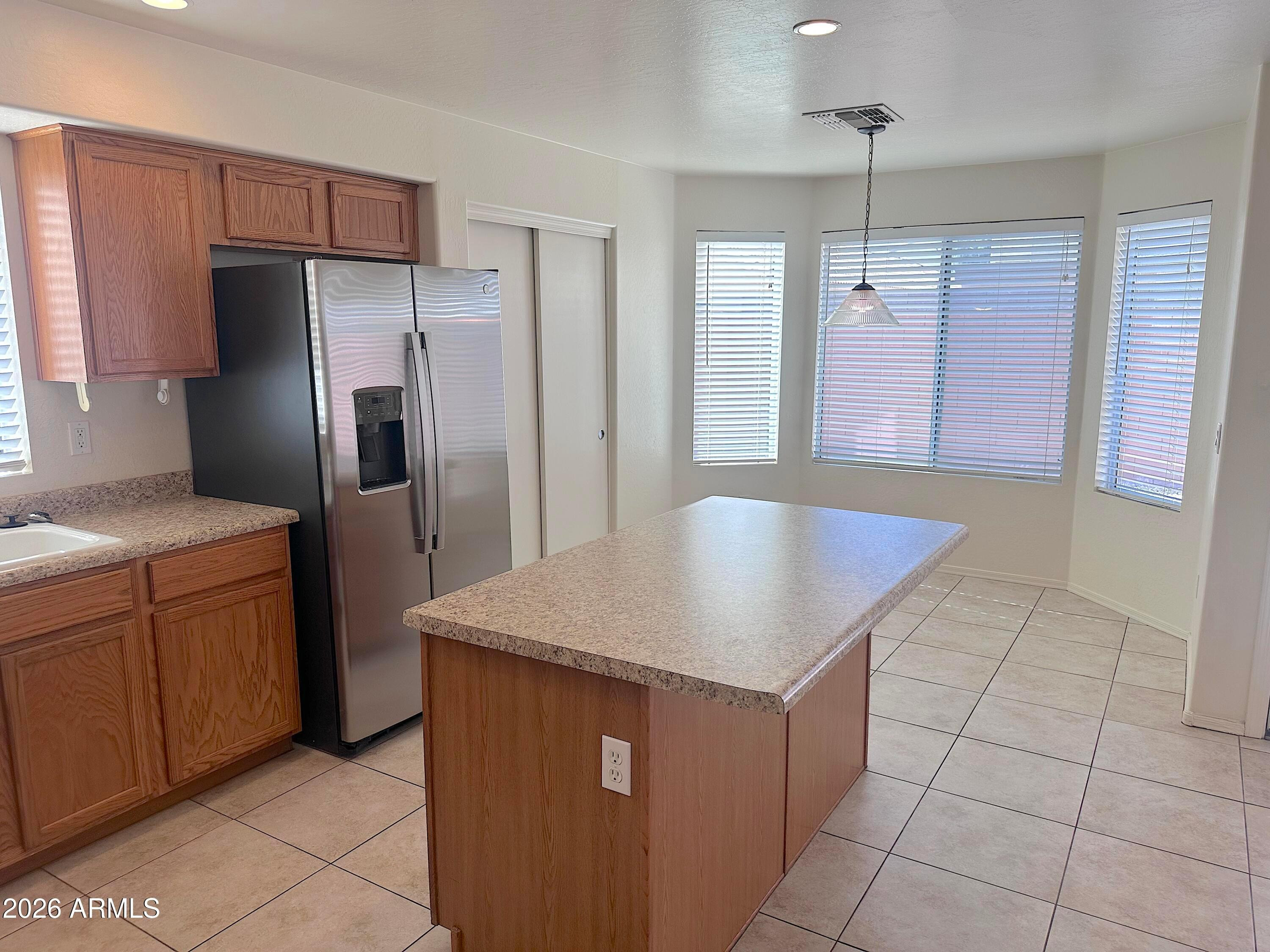 4106 East Chambers Street Phoenix, AZ 85040 - Photo 8 of 33 a kitchen with cabinets and stainless steel appliances