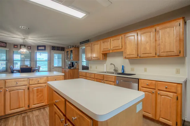 a kitchen with stainless steel appliances a table and chairs