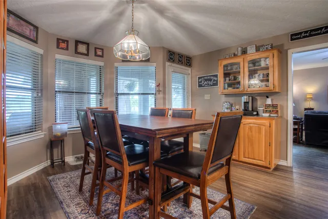 a dining room with furniture and wooden floor