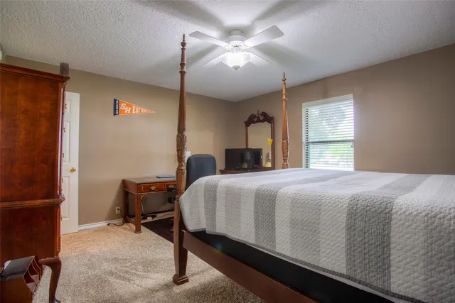 a spacious bathroom with a granite countertop sink and a mirror