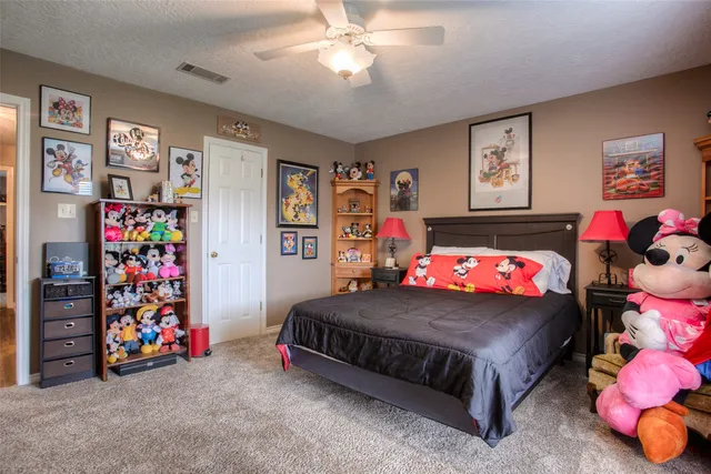 a kitchen with stainless steel appliances granite countertop a refrigerator a sink dishwasher and wooden cabinets with wooden floor