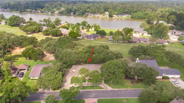 an aerial view of lake residential house with outdoor space and trees around