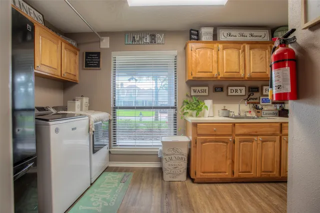 a kitchen with a sink cabinets stainless steel appliances and a large window