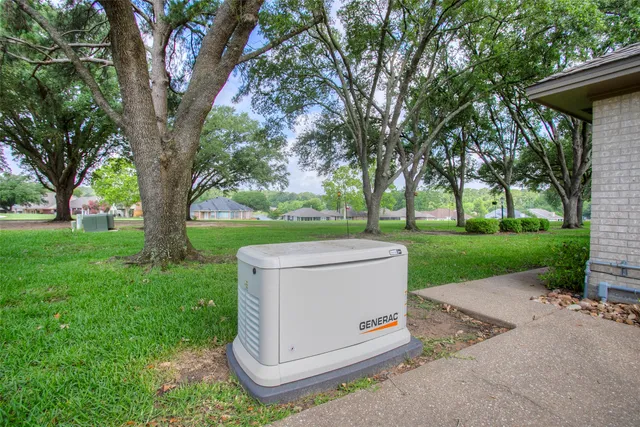 a front view of a house with a yard and potted plants