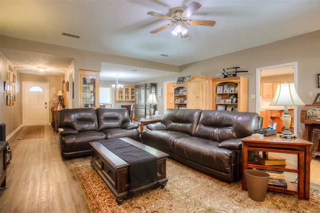 a living room with furniture a fireplace and a flat screen tv
