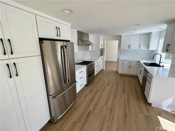 a kitchen with a refrigerator a sink and dishwasher