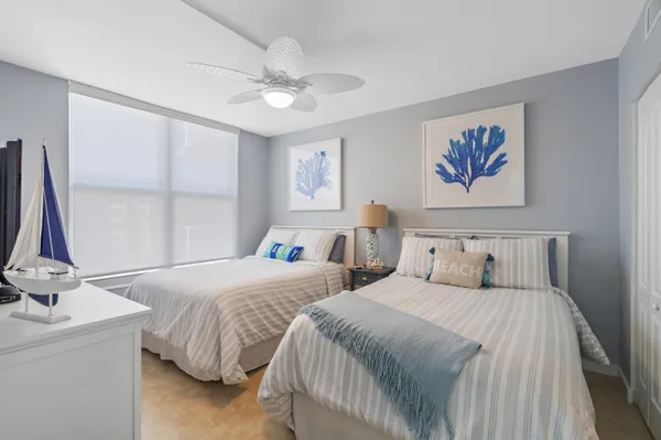 a bedroom with a bed and painting on the wall