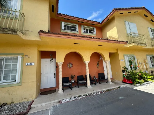 a backyard of a house with table and chairs