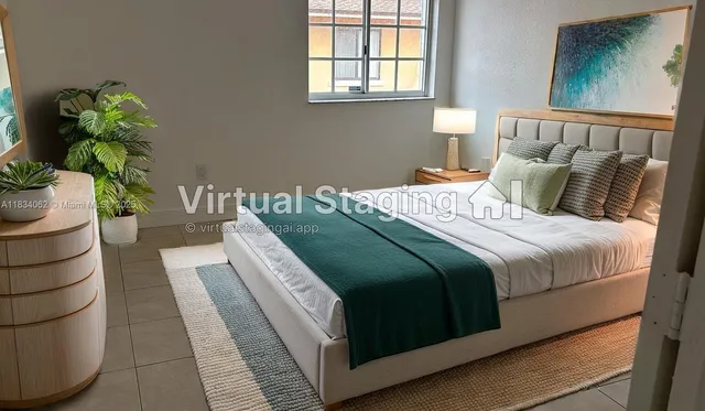 a bedroom with a bed lamp and a potted plant