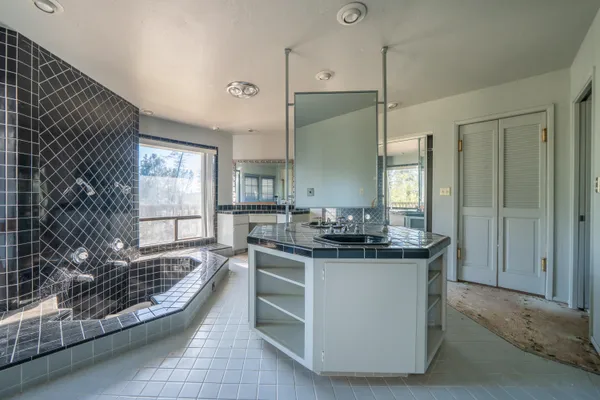 a kitchen with granite countertop a stove and a sink