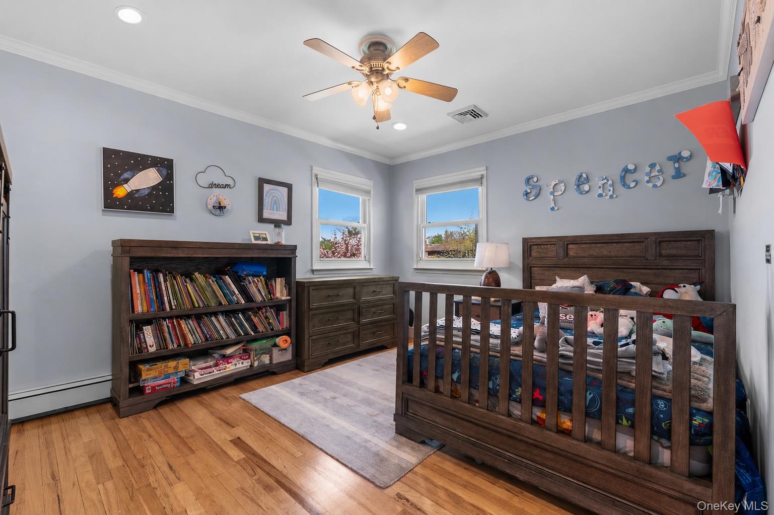 61 Winthrop Road Plainview, NY 11803 - Photo 20 of 37 a bedroom with furniture window and book shelfs