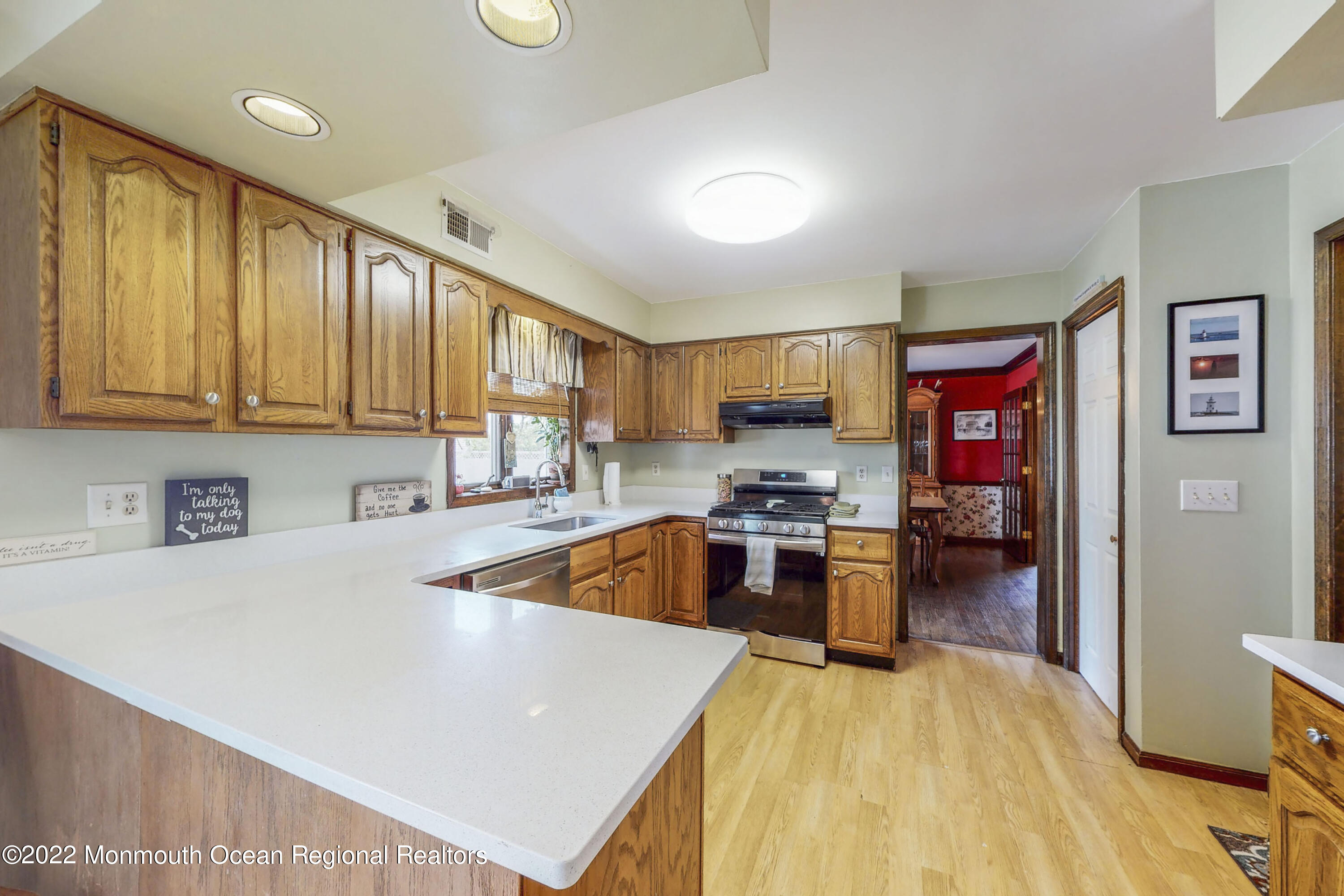 193 Binnacle Road Brick, NJ 08723 - Photo 8 of 34 a kitchen with a refrigerator a stove top oven a sink dishwasher and wooden cabinets with wooden floor