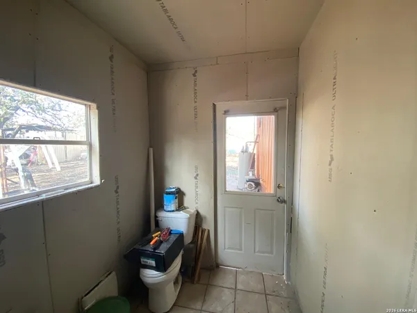 a bathroom with a toilet and a shower curtain