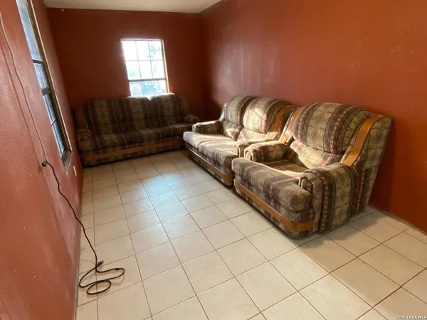 a living room with couch and a window