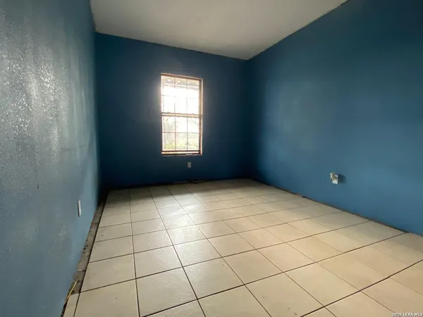 a view of an empty room and a window