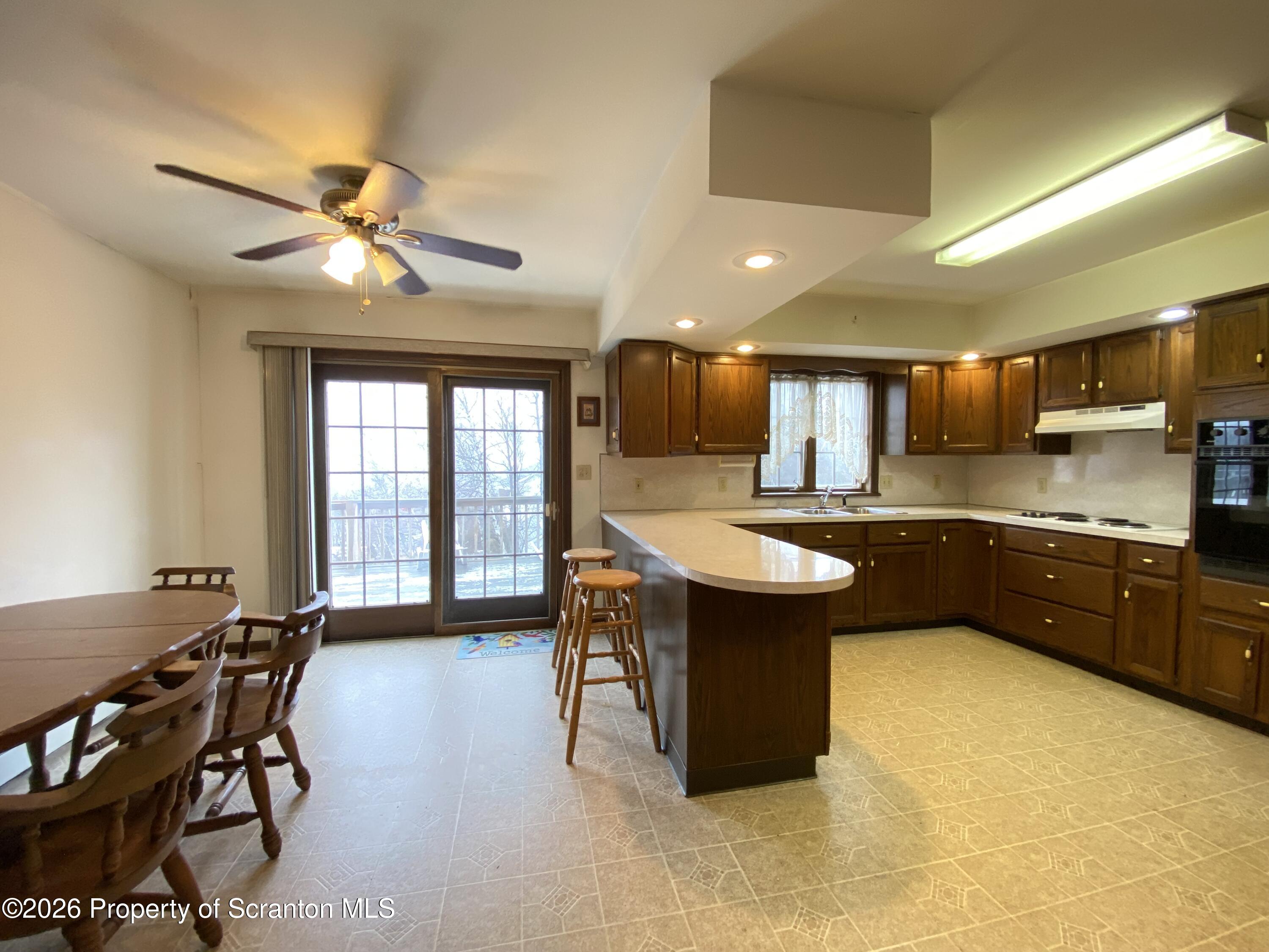 1303 Ridgewood Avenue Scranton, PA 18505 - Photo 11 of 57 a kitchen with a table chairs sink and cabinets