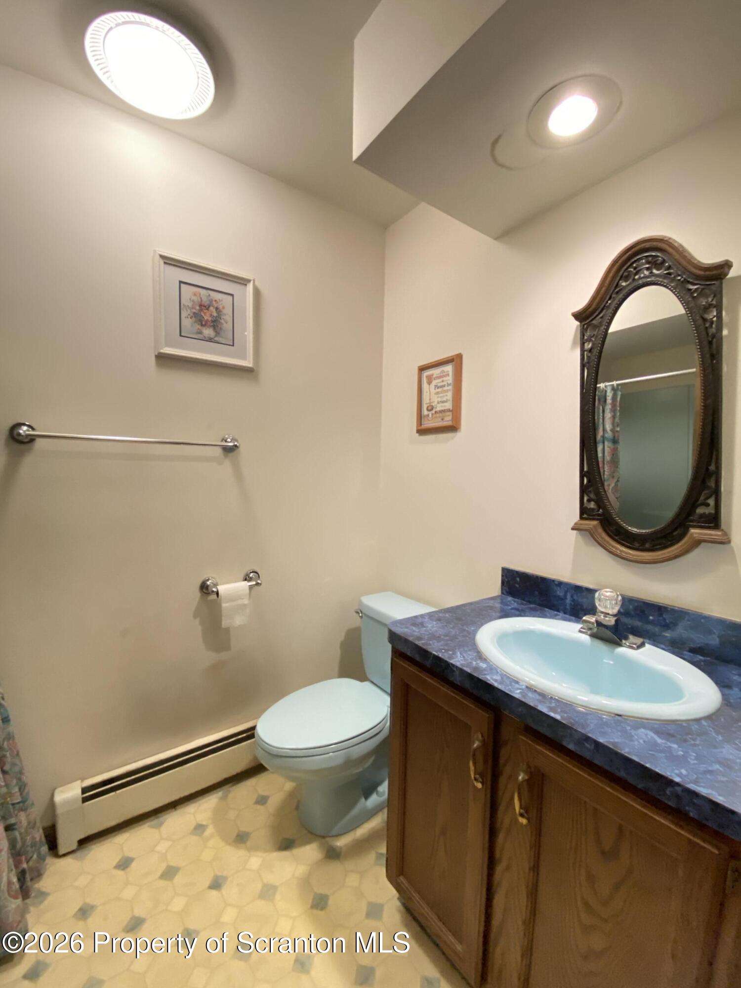 1303 Ridgewood Avenue Scranton, PA 18505 - Photo 13 of 57 a bathroom with a sink a toilet and mirror