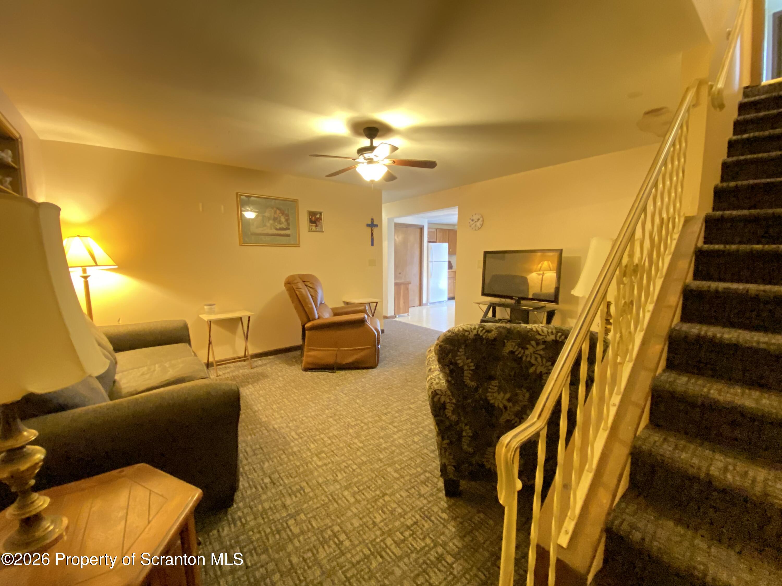1303 Ridgewood Avenue Scranton, PA 18505 - Photo 26 of 57 a living room with furniture and a chandelier