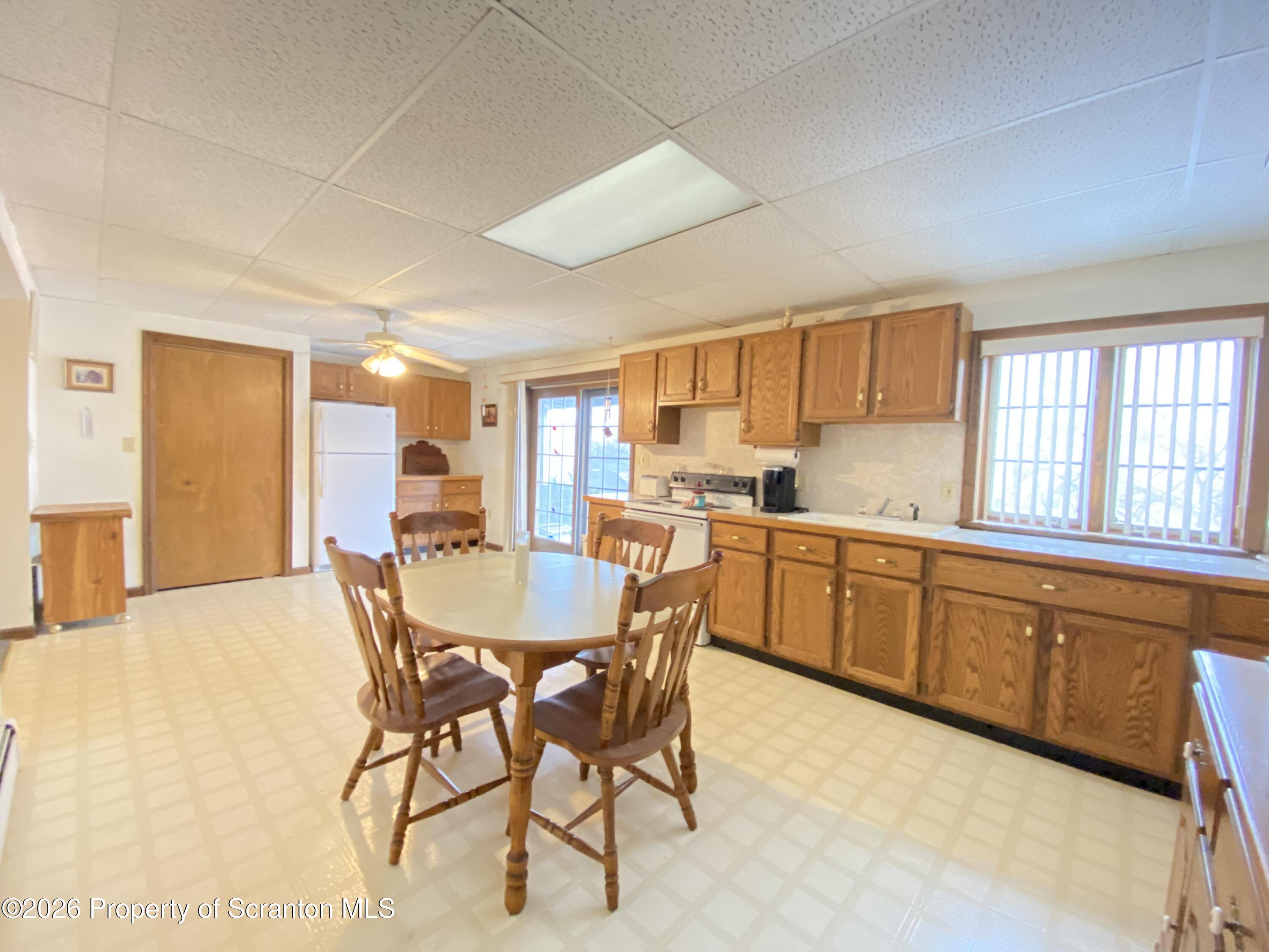 1303 Ridgewood Avenue Scranton, PA 18505 - Photo 29 of 57 a kitchen with stainless steel appliances granite countertop a sink a stove a dining table and chairs