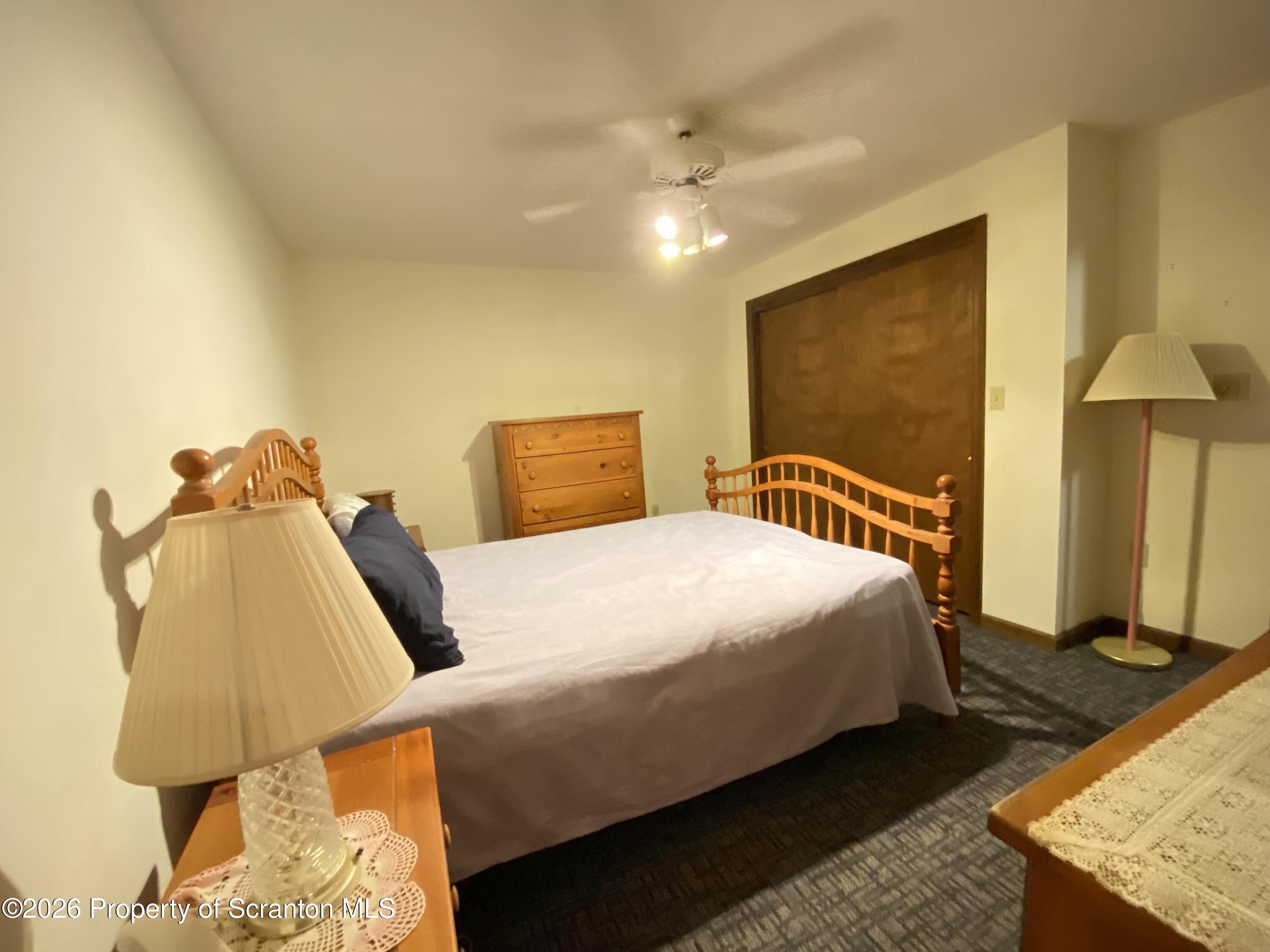 1303 Ridgewood Avenue Scranton, PA 18505 - Photo 35 of 57 a bedroom with a bed and lamp on dresser