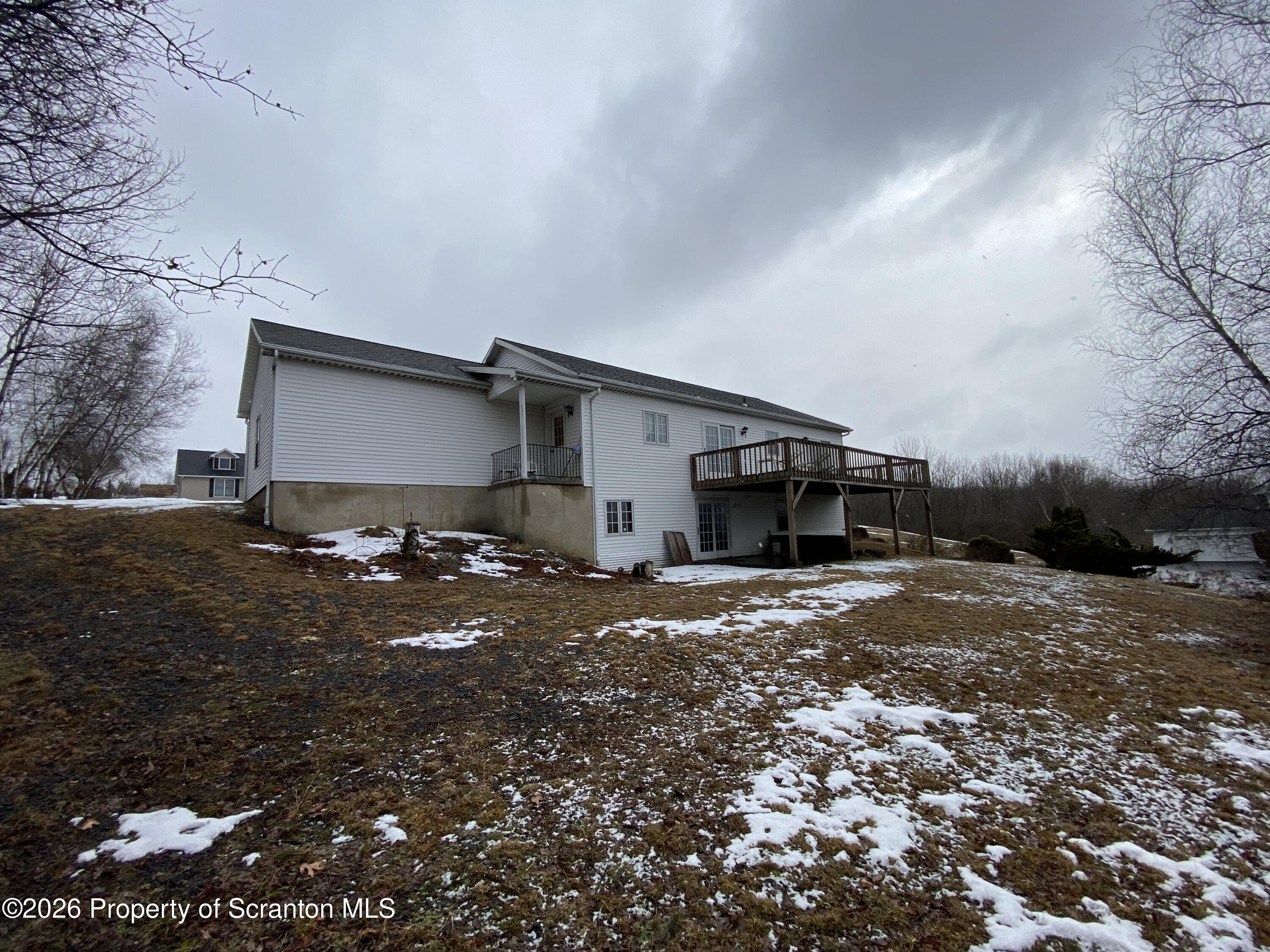 1303 Ridgewood Avenue Scranton, PA 18505 - Photo 53 of 57 a front view of a house with a yard and garage