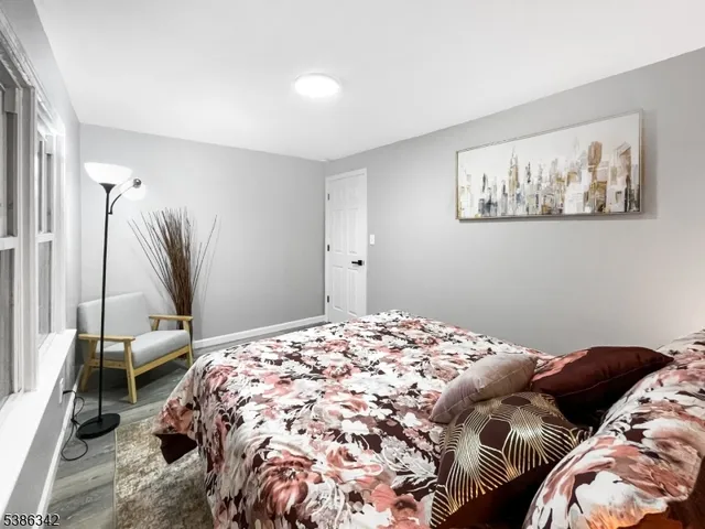 a bedroom with a bed and a painting on the wall