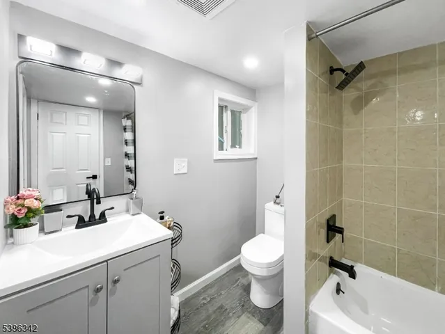 a bathroom with a sink toilet tub and shower