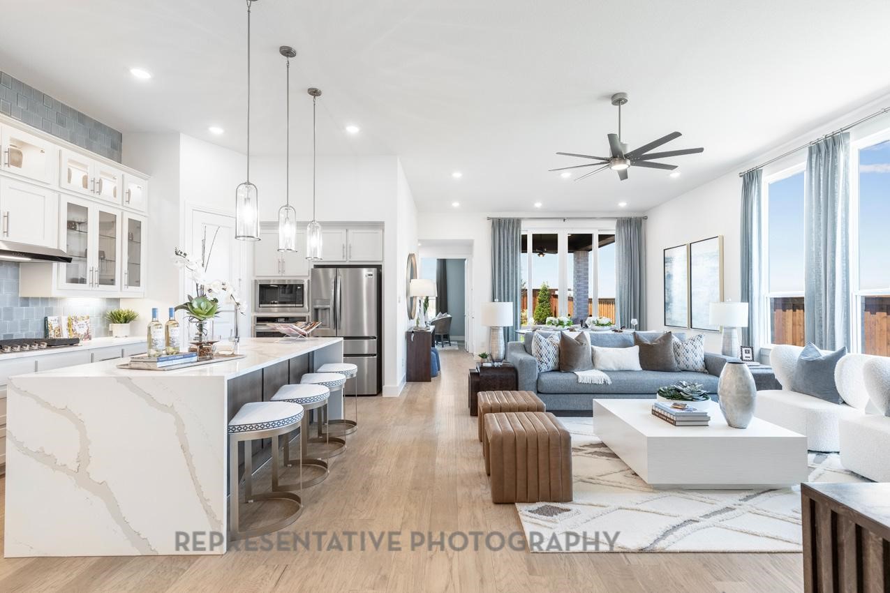 22214 Mount Whitney Road Waller, TX 77484 - Photo 12 of 50 a living room with furniture kitchen view and a chandelier